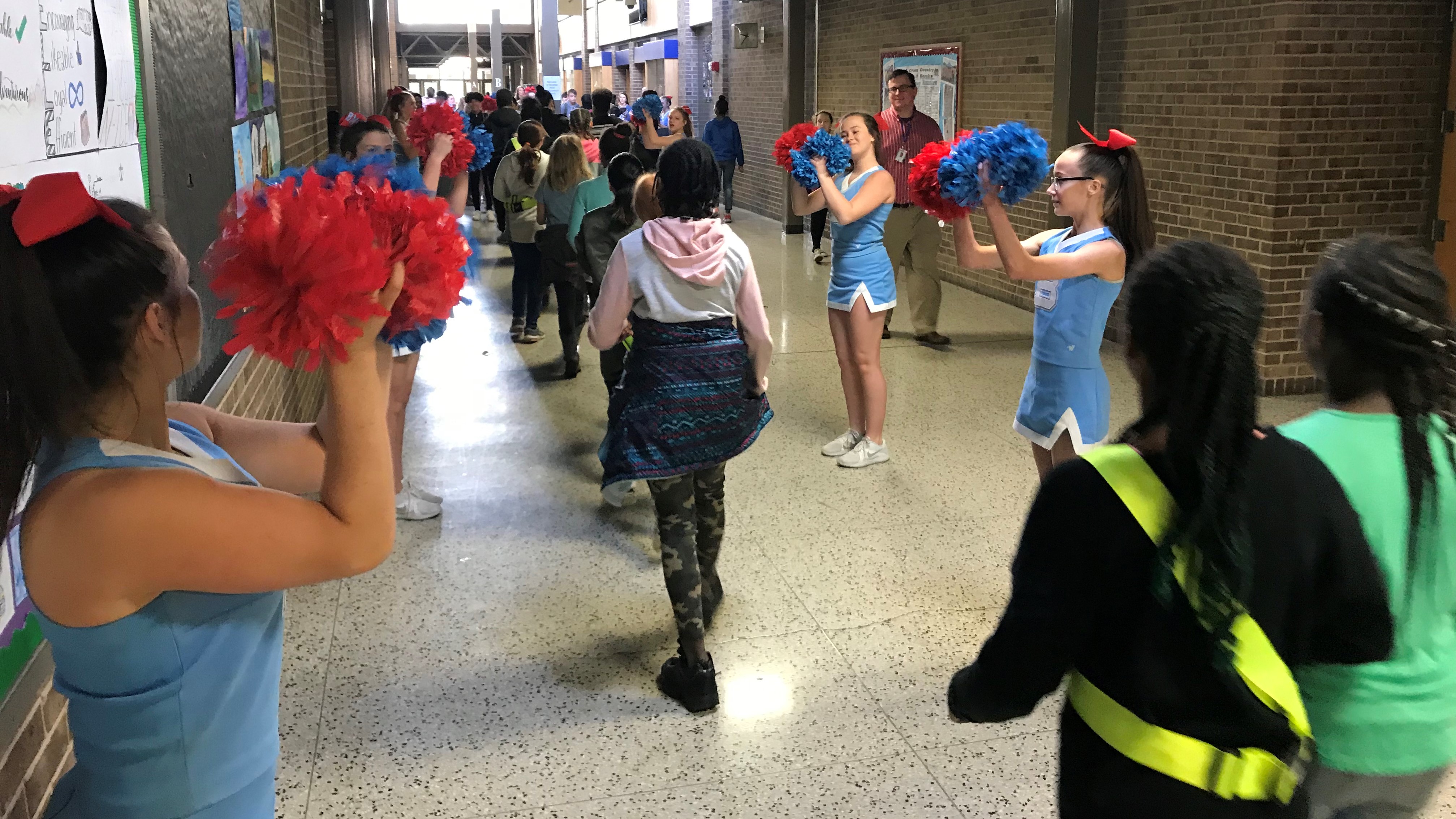 At Bearden Middle School, cheerleaders give a 'positive welcome' to 5th-graders arriving for orientation. 